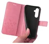 A hand is holding open a pink floral patterned flip phone case, revealing the black interior where a phone would be placed. Produktbild-Vorschau