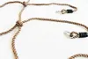 A close-up view of brown ropes with metal clasps and black rubber grips, arranged on a white background. Produktbild-Vorschau
