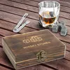 A whiskey stones gift set with a wooden box, tongs, and a glass of whiskey with stones. Produktbild-Vorschau