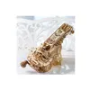 A wooden 3D puzzle of a musical instrument is displayed on a white surface with a decorative white background. Produktbild-Vorschau