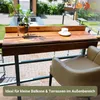 A wooden balcony table attached to a railing, with a plant and a cup of coffee on it, and a chair next to it. Produktbild-Vorschau