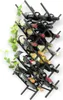 A black metal wine rack filled with wine bottles, with a green vine plant on the left side. Náhled obrázku produktu