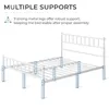 A diagram illustrating the multiple support points of a white metal bed frame. Produktbild-Vorschau