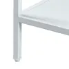 A close-up view of the bottom corner of a white metal table leg and shelf. Produktbild-Vorschau