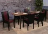 A dining table with chairs set up in a room with a stone wall and a plant. Náhľad obrázku produktu