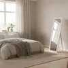 A bedroom scene with a bed and a full-length mirror. Náhľad obrázku produktu