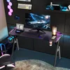 A gaming desk setup with a computer, monitor, keyboard, and chair, illuminated by LED lights. Produktbild-Vorschau