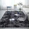 A shaggy rug in a living room setting with a sofa, coffee table, and laptop. Náhled obrázku produktu
