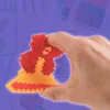 A hand holding a Christmas-themed craft made of beads. Produktbild-Vorschau