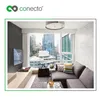 A modern living room with a TV mounted on the wall, a sofa, and a large window overlooking a city skyline. Produktbild-Vorschau