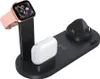 A black 4-in-1 wireless charging station with an Apple Watch, AirPods case, and a charging port for a phone. Produktbild-Vorschau