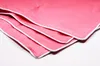 A close-up, folded view of a pink blanket with white piping. Produktbild-Vorschau