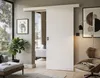 A modern living room with a sliding door, armchair, and plant. Produktbild-Vorschau