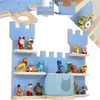 A blue castle-shaped wall shelf filled with various small toys and figures. Náhled obrázku produktu