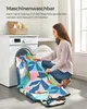 A woman is placing a colorful blanket into a washing machine. Náhled obrázku produktu