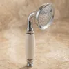 A vintage-style shower head with a ceramic handle, emitting steam. Podgląd zdjęcia produktu