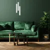 A living room scene with a green sofa, coffee tables, a plant, and pendant lights. Anteprima dell’immagine prodotto