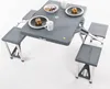 A portable picnic table with four attached seats, set up on a white background. Produktbild-Vorschau