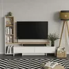 A modern living room setup with a TV stand, TV, bookshelf, and floor lamp. Náhled obrázku produktu