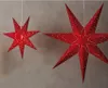 Two red paper star lanterns with small white lights are hanging against a gray background. Produktbild-Vorschau