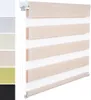 A close-up view of a roller blind with alternating opaque and sheer stripes, showcasing its wood-look texture and white fabric.