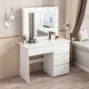 A white vanity table with a lighted mirror and drawers, set against a neutral wall and wooden floor. Podgląd zdjęcia produktu
