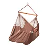 A woman is relaxing in a brown hammock chair. Produktbild-Vorschau