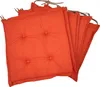 A stack of orange seat cushions.