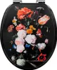 A toilet seat with a floral print on a black background. Produktbild-Vorschau