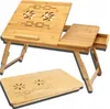 A wooden laptop table with a drawer and ventilation holes is shown. A second, folded table is placed in front of it. Produktbild-Vorschau