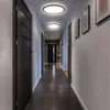 A modern hallway with dark wooden doors and sleek, circular LED ceiling lights. Produktbild-Vorschau