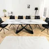 A dining room with a marble-top table and black chairs. Produktbild-Vorschau