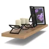 A wooden shelf with a candle holder and two picture frames. Produktbild-Vorschau