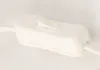 A close-up shot of a white inline cord switch for a lamp. Náhled obrázku produktu