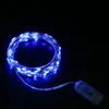 A coiled string of blue LED lights with a small battery pack attached. Produktbild-Vorschau