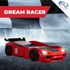 A red race car-shaped children's bed is displayed on a checkered background, suggesting a racing theme. Produktbild-Vorschau