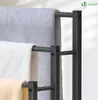 Close-up of a black metal towel rack with three towels hanging on it. Produktbild-Vorschau