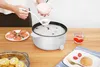 A person is serving food from an electric pot into a bowl. Produktbild-Vorschau