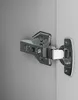 A close-up of a cabinet hinge attached to two surfaces. Produktbild-Vorschau