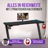 A black gaming desk with a monitor, LED lighting, and accessories like a cup holder and headphone hook. Voir les images du produit