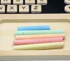A close-up view of colorful chalk sticks laid out on a wooden surface. Produktbild-Vorschau