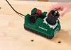 A hand is shown inserting a drill bit into a green PARKSIDE drill bit sharpener on a wooden workbench. Produktbild-Vorschau