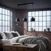 A bedroom with a bed, brick walls, and large windows. Náhled obrázku produktu