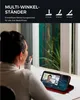A woman is on a video call on her phone, which is propped up on a desk. Produktbild-Vorschau
