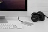 A desk setup with a computer, keyboard, mouse, external hard drive, and a DSLR camera. Anteprima dell’immagine prodotto
