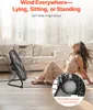 A woman sitting on the floor enjoying the airflow from a fan in a living room. Voir les images du produit