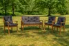A set of outdoor furniture, including a bench and two chairs, placed on a grassy lawn with trees in the background. Produktbild-Vorschau
