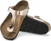 A pair of rose gold Birkenstock Gizeh sandals shown from a slightly elevated angle against a white background. Produktbild-Vorschau