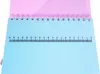 A close-up view of a spiral-bound notebook with a ruler printed on the cover. Produktbild-Vorschau