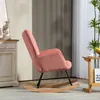 A pink corduroy rocking chair is shown in a room with a side table and plants. Náhled obrázku produktu